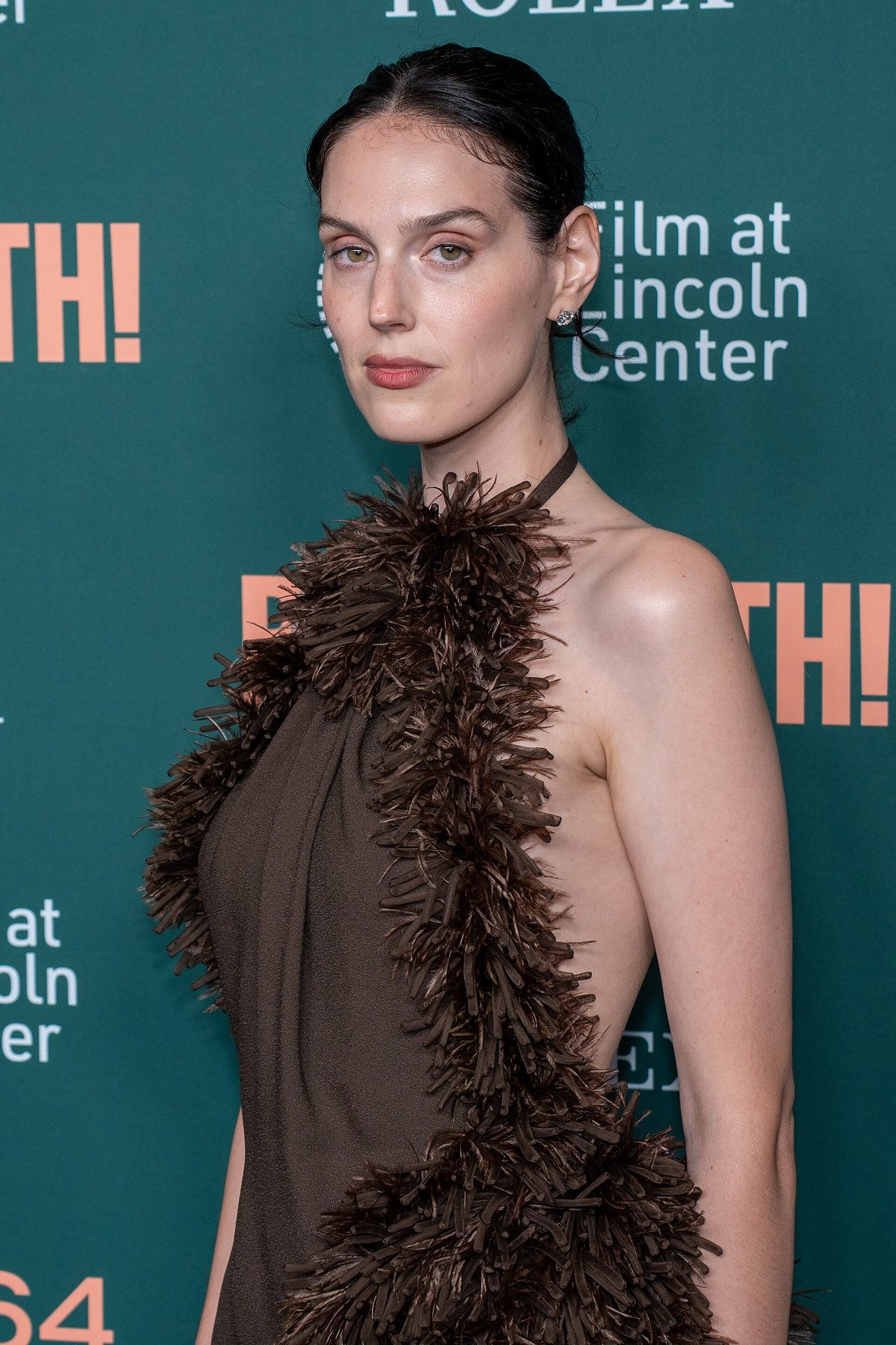 Eva Victor in a chocolate-brown Loewe gown with feather fringe at the Behemoth! premiere, 2026 New York Film Festival
