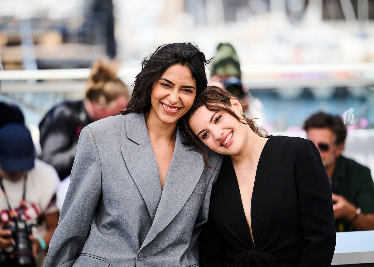 Two women at a 2026 Cannes Film Festival photocall in tailored blazers over open necklines, a structured-plus-relaxed pairing typical of smart casual (file photo illustrating the dress code generally, not a specific outfit review)