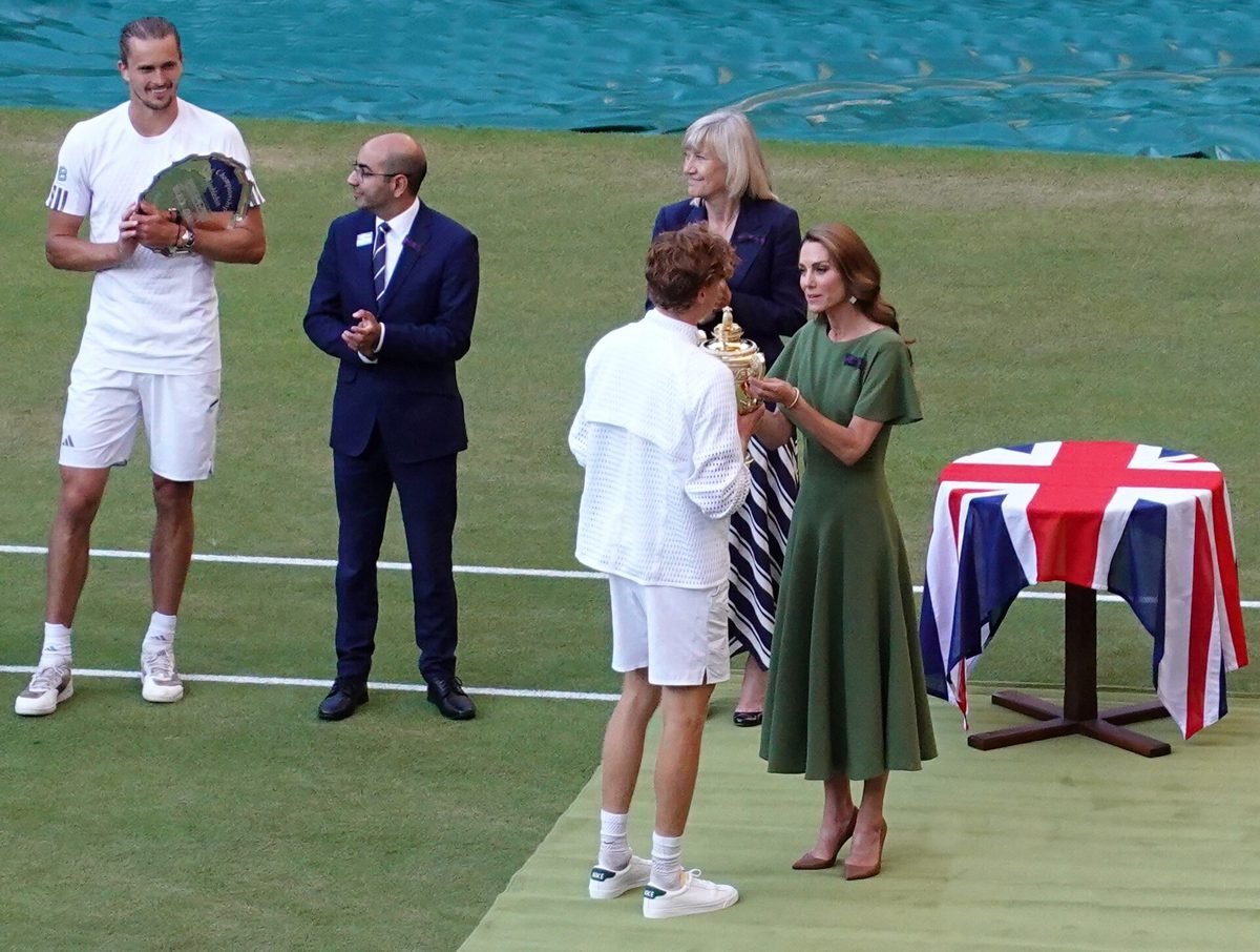 Catherine, Princess of Wales, in a green knee-length, short-sleeved dress at the 2026 Wimbledon trophy presentation — a real example of the daytime semi-formal length and silhouette this guide describes, not a styled 'get the look' outfit